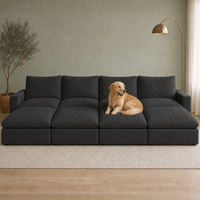 4 Seat SkyLux Nest Cloud Couch in Black — four seats each with its own ottoman forming a continuous platform, golden retriever curled on the platform