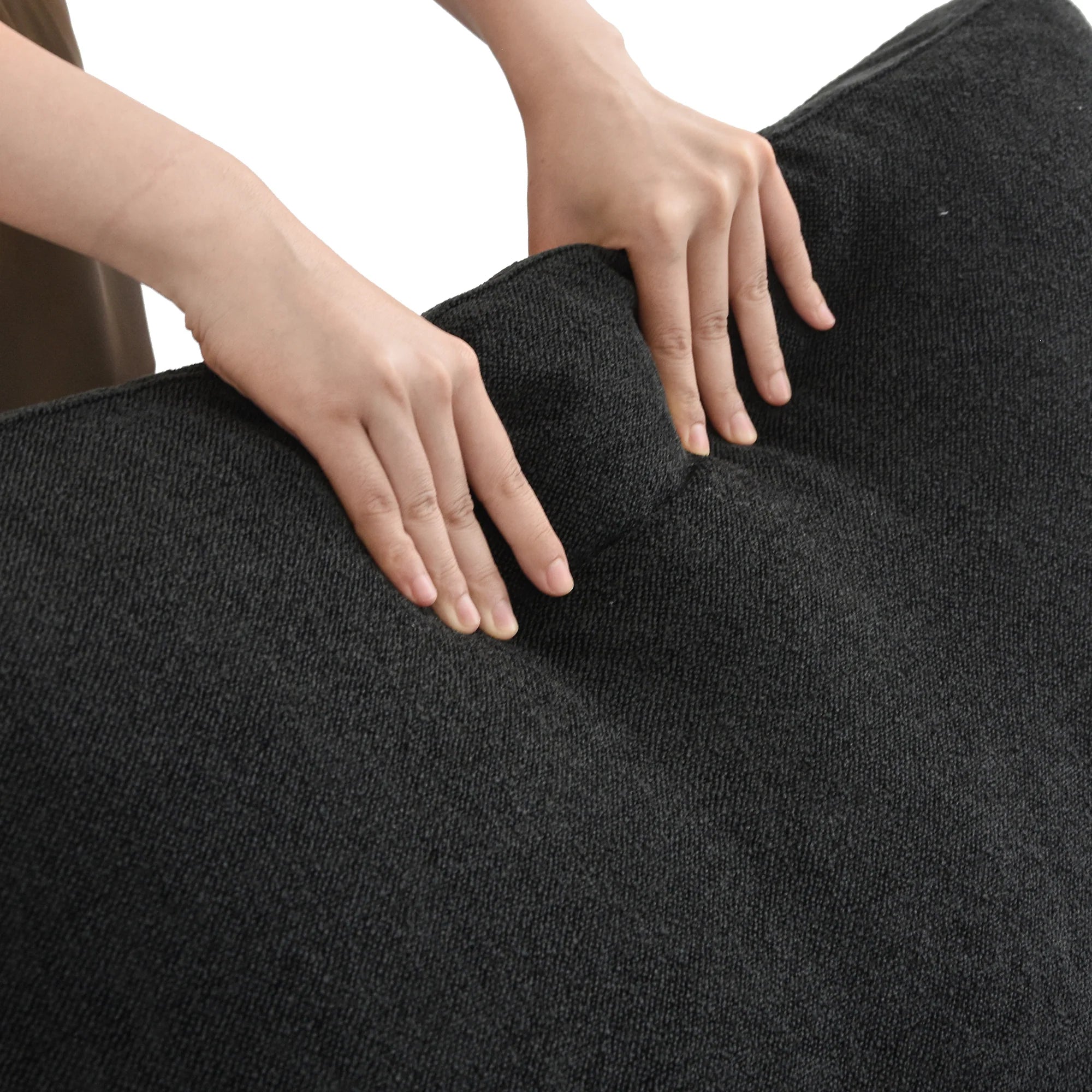 SkyLux Extra Cover Set in Black — close-up of the boucle weave as hands press into the cushion